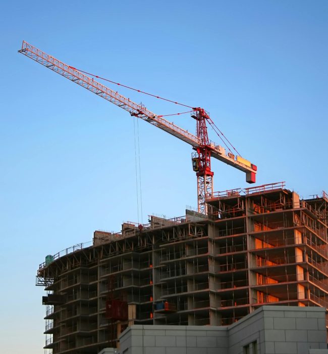 pexels-photo-93400-93400 Tower crane on a high-rise building under construction at sunset, showcasing modern urban development.